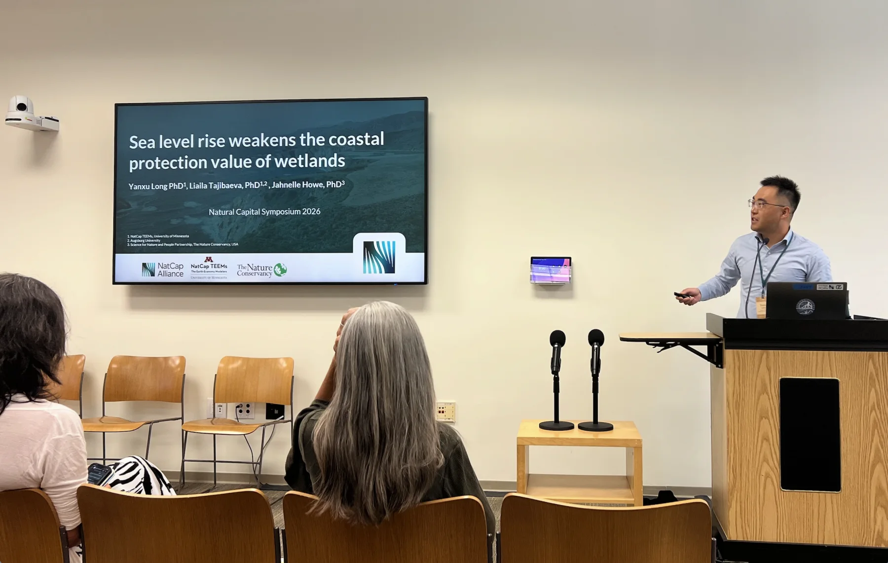 Yanxu Long presenting research on sea level rise and wetland coastal protection